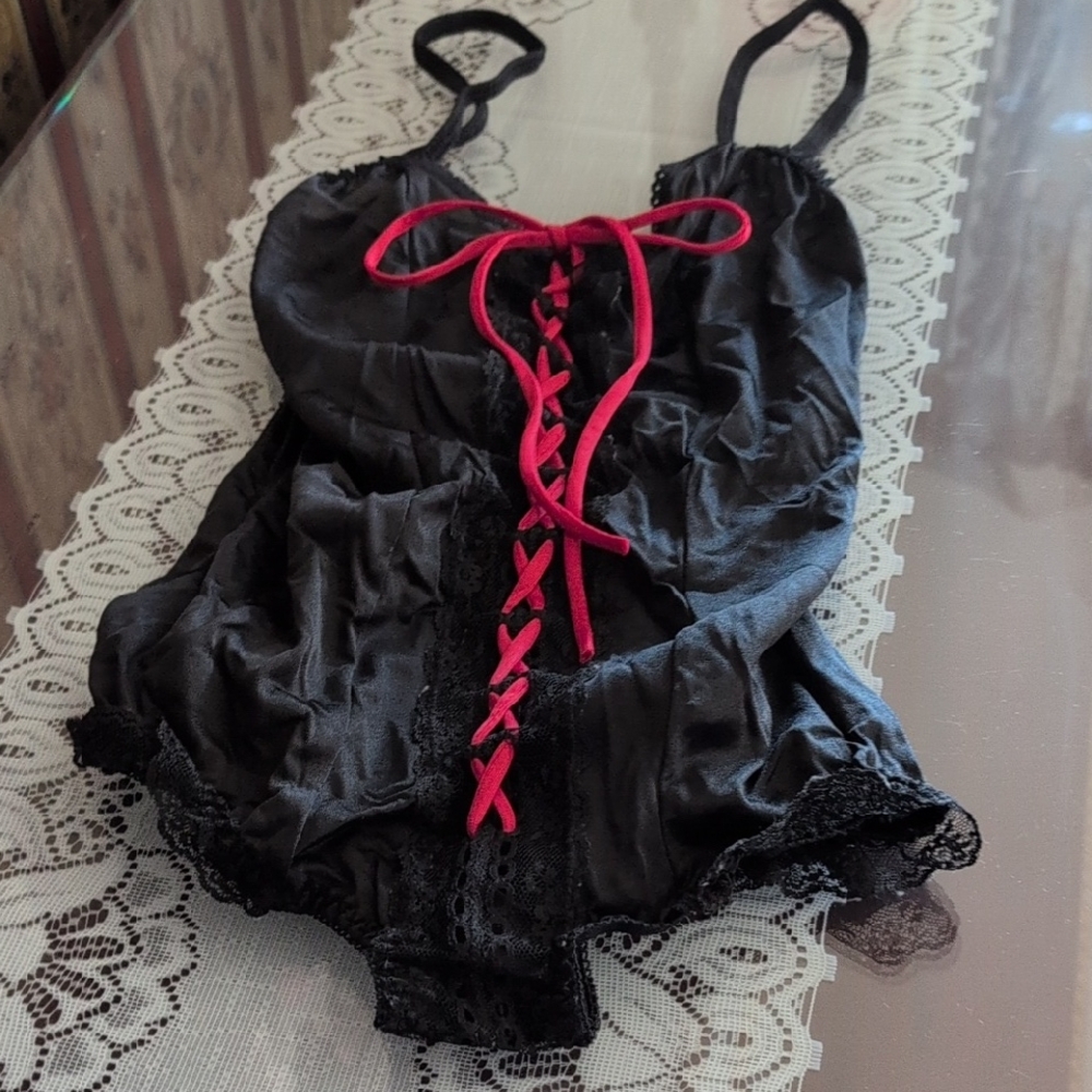 Black Satiny Looking Teddy With Red Tie Front.  Lace Around Legs.
